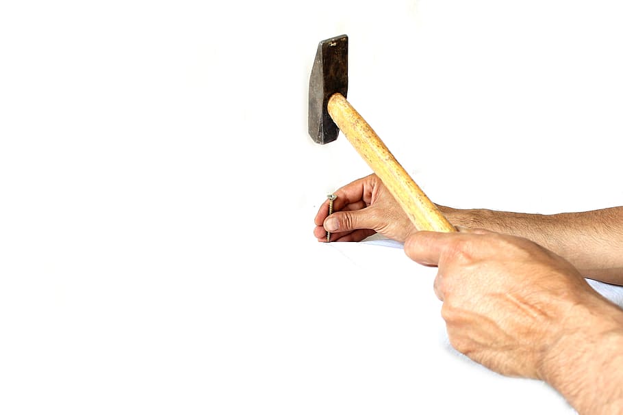 person's hand holding common nail and hammer, employee, white HD wallpaper