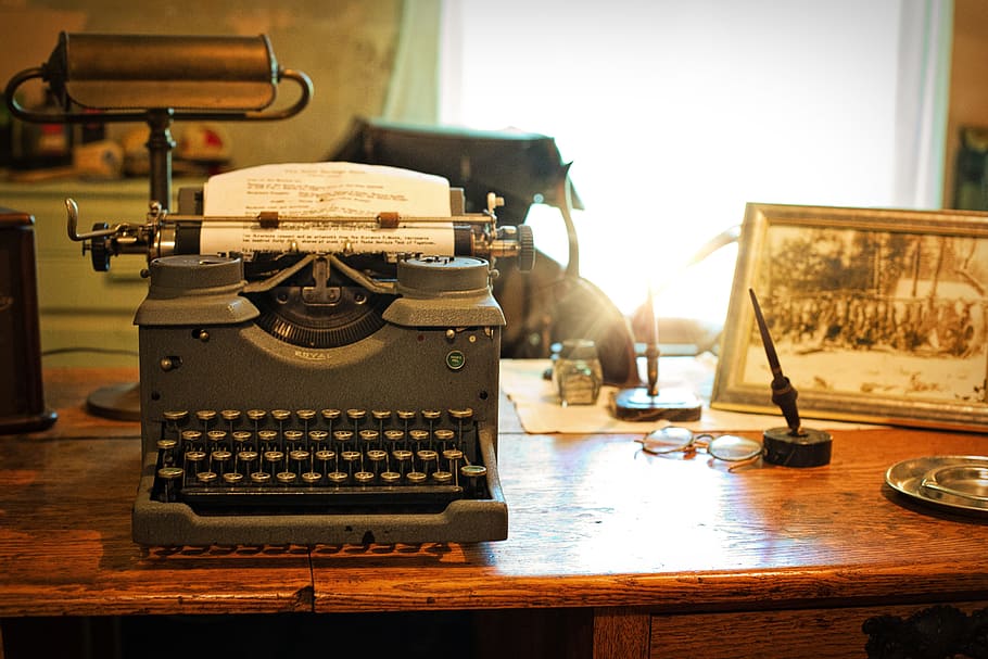 vintage gray typewriter on brown wooden table, steel, type writer
