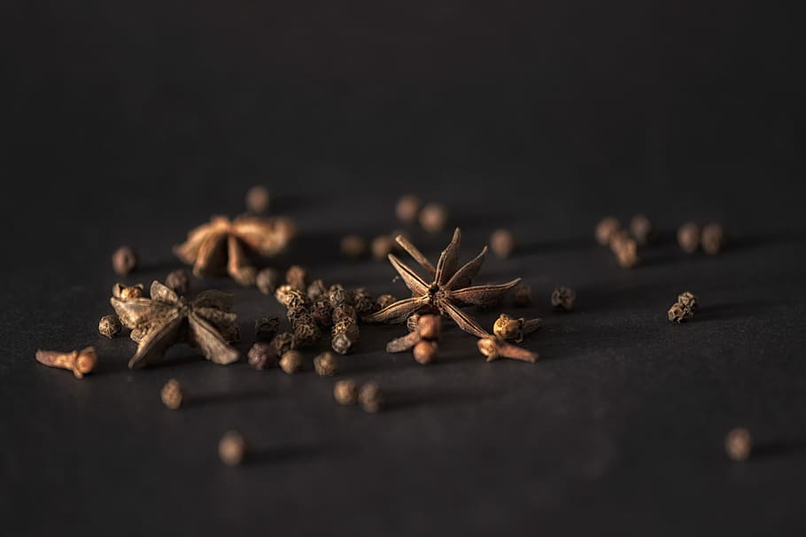 selective focus photography of star anise, selective brown pepper HD wallpaper