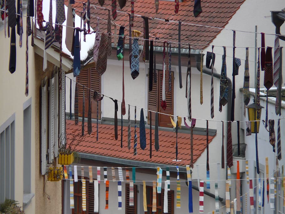 assorted-color necktie buntings near buildings at daytime, fat thursday