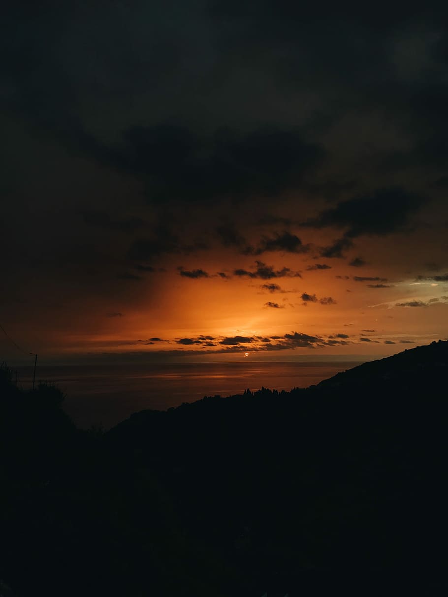 silhouette photograph of mountain range during golden hour, mountain under black sky HD wallpaper