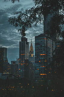 city lights at nighttime, silhouette photo of Chrysler building under gloomy sky HD wallpaper