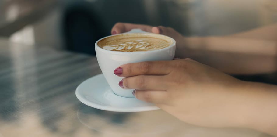 person holding white ceramic teacup, person holding cup of coffee on saucer HD wallpaper