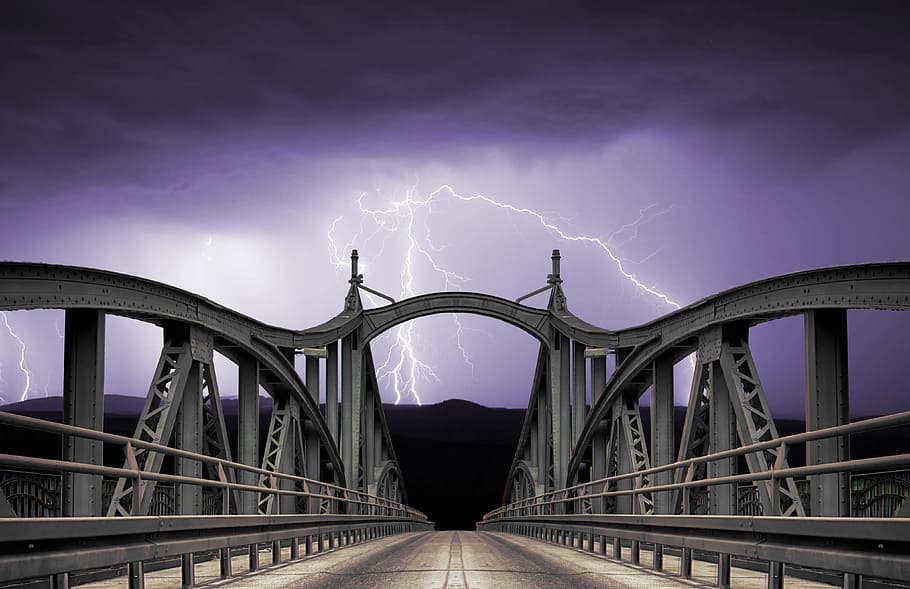 grey metal suspension bridge under cloudy skies with lightnings HD wallpaper