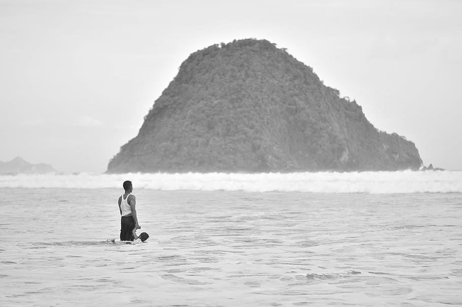 man standing on seashore near island, human, child, family, beach, HD wallpaper
