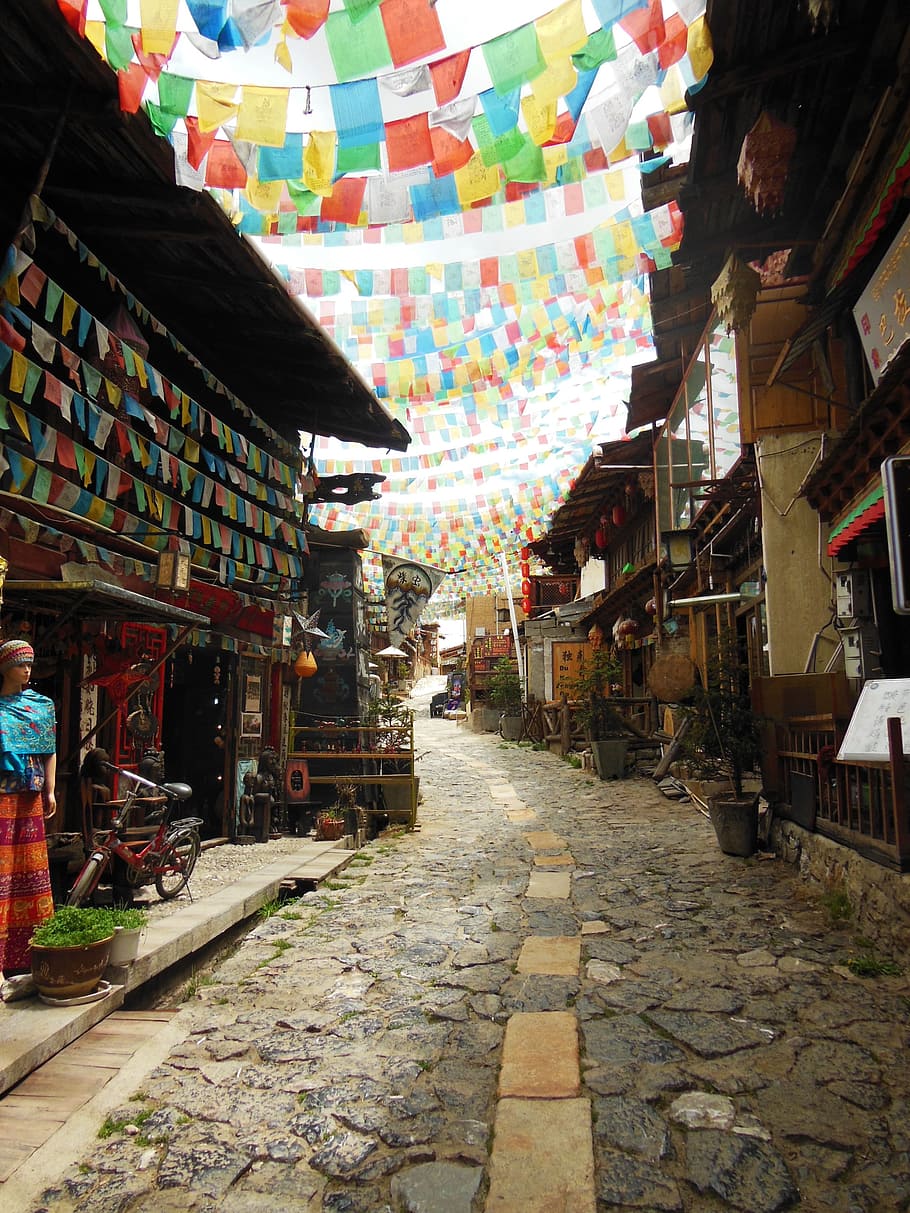 photo of town with buntings, shangri la, yunnan, china, architecture