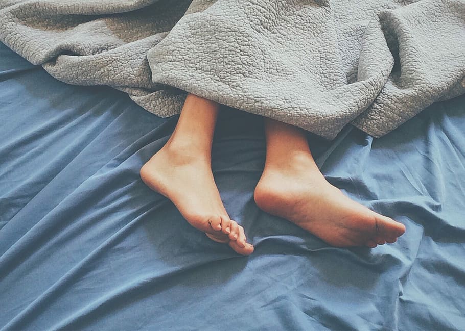 person laying on blue bed with gray blanket, fabric, textile HD wallpaper