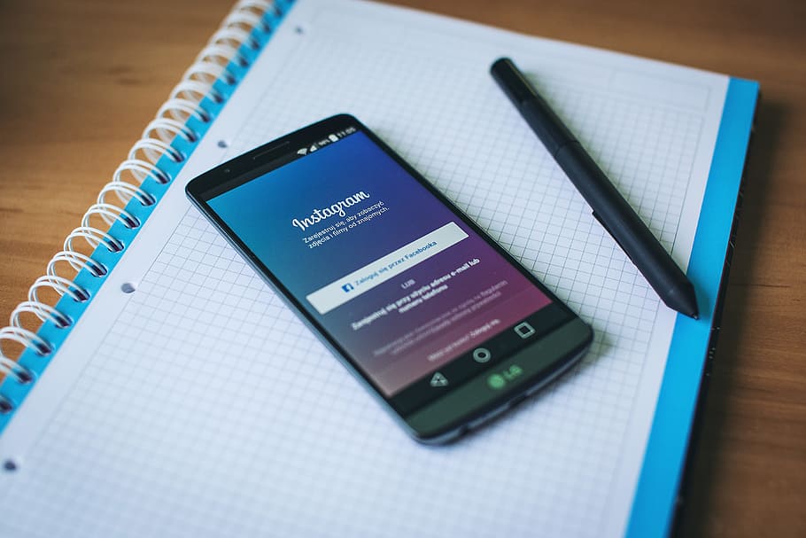 black LG smartphone with pen on graphing notebook, instagram HD wallpaper