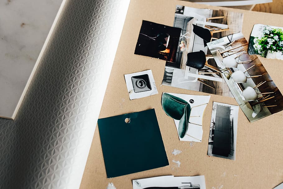 Designers working with material samples and paper cutouts, fabric HD wallpaper