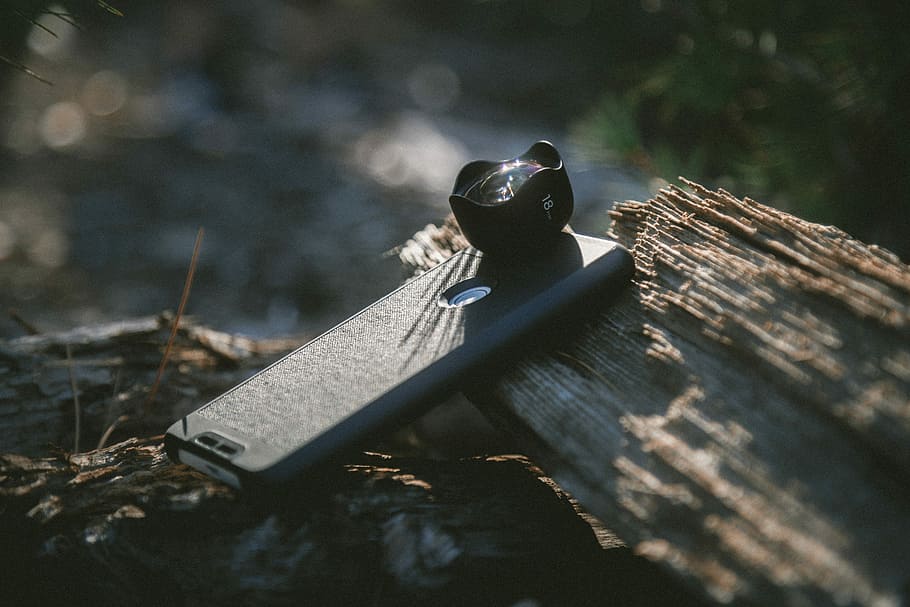 black smartphone with camera lens on tree log, black Android smartphone HD wallpaper