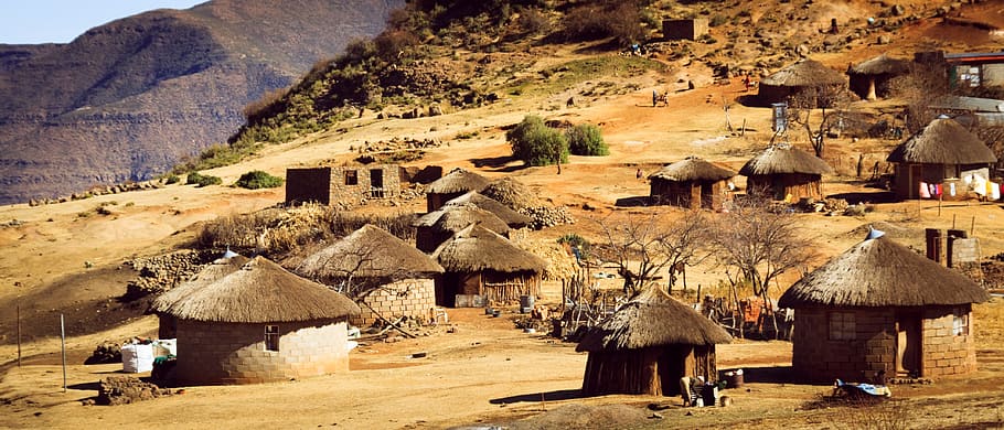 village on mountainside during daytime, lesotho, africa, cabins