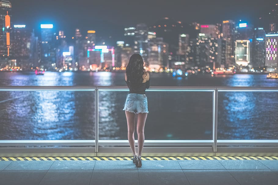 Woman Watching View of Metropolis during Nighttime, architecture