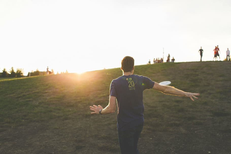 man standing on grass field, people, guy, play, highland, sunshine HD wallpaper
