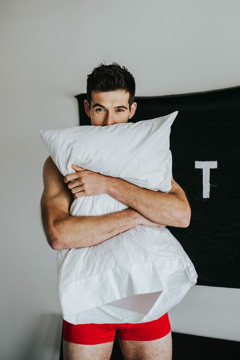 Man holding cheap pillow