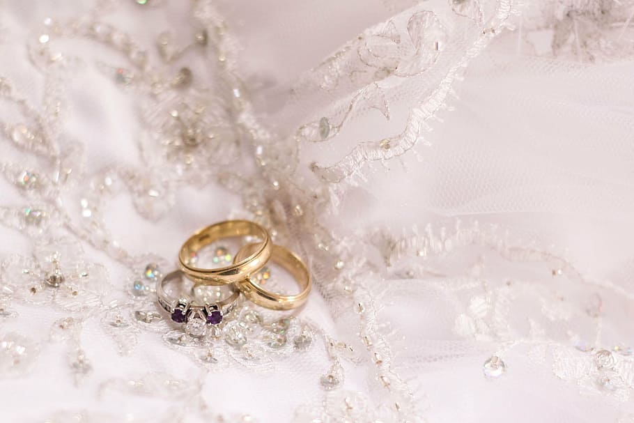 two gold-colored and one silver-colored rings, wedding, dress