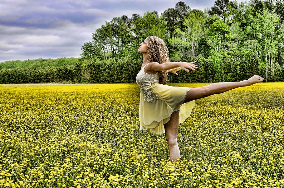woman dancing on yellow rapeseed flower field during daytime HD wallpaper