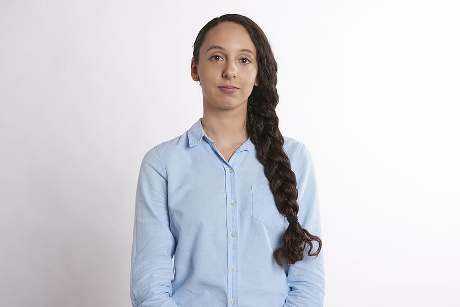 woman wearing blue dress shirt, serious, bored, satisfied, female