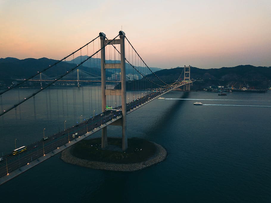 grey concrete bridge over body of water during daytime, three boats crossing under bridge during golden hour HD wallpaper
