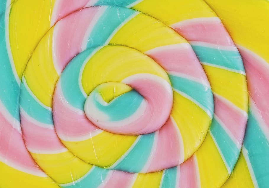 closeup photo of spiral yellow and multicolored candy, rainbow