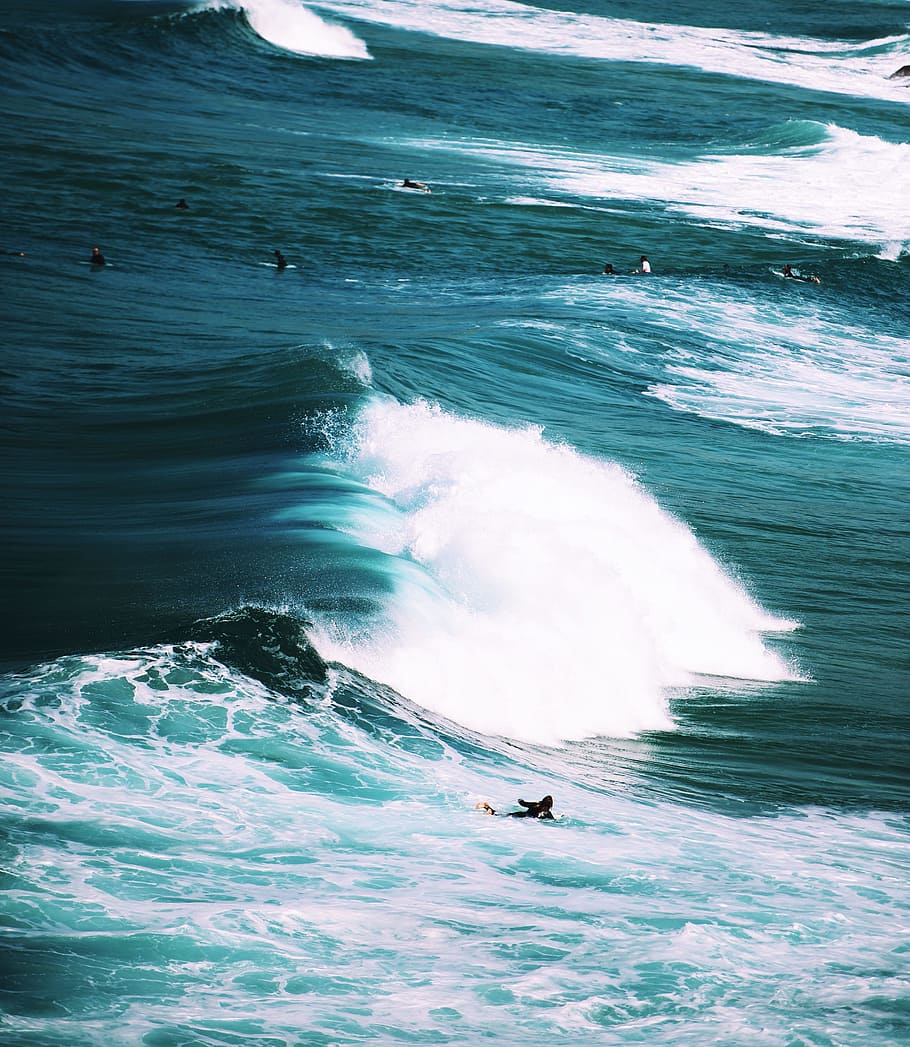 person on surfboard with ocean waves, group of surfers on body of water HD wallpaper