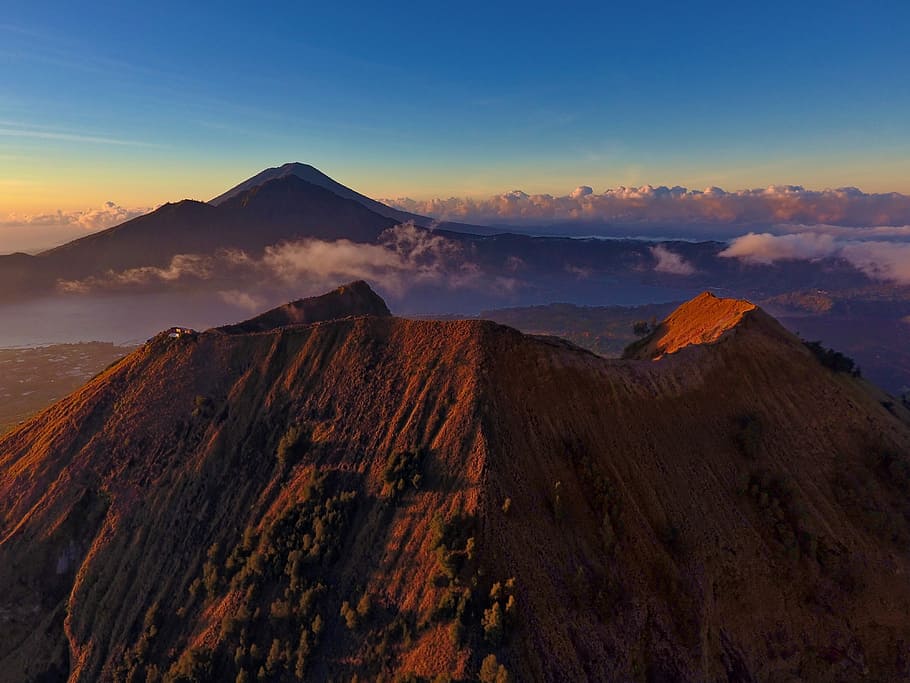 aerial photography of mountain, mountain near mountain under blue sky HD wallpaper
