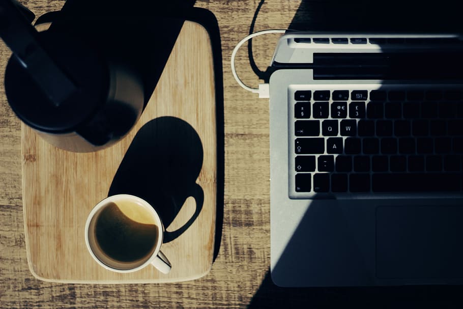 two black and white mugs on rectangular brown tray, flat lay photography of mug beside kettle and laptop HD wallpaper