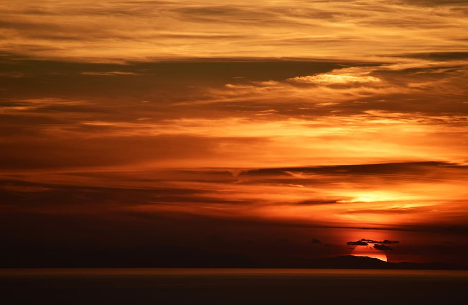 silhouette of clouds during dawn, silhouette of island during golden hour HD wallpaper