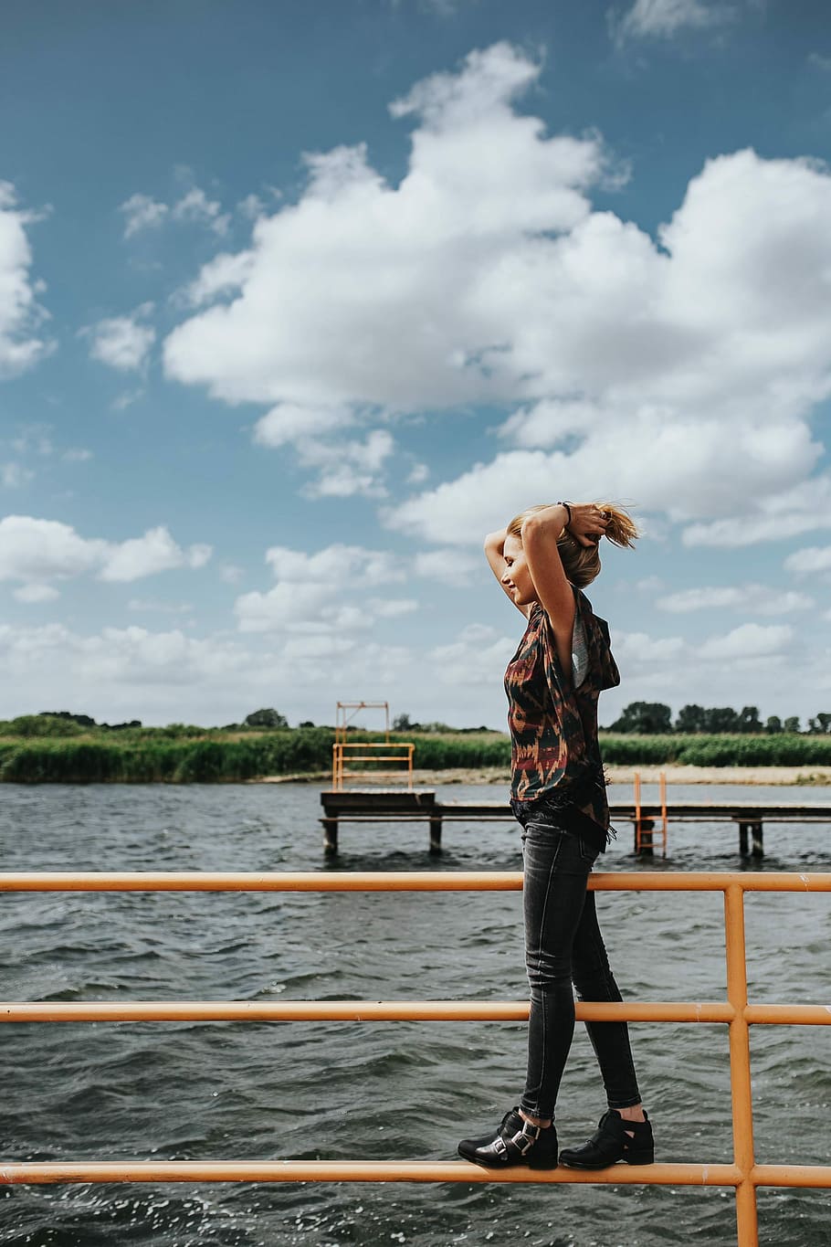 Beautiful blonde woman on a wooden pier by the lake, female, girl