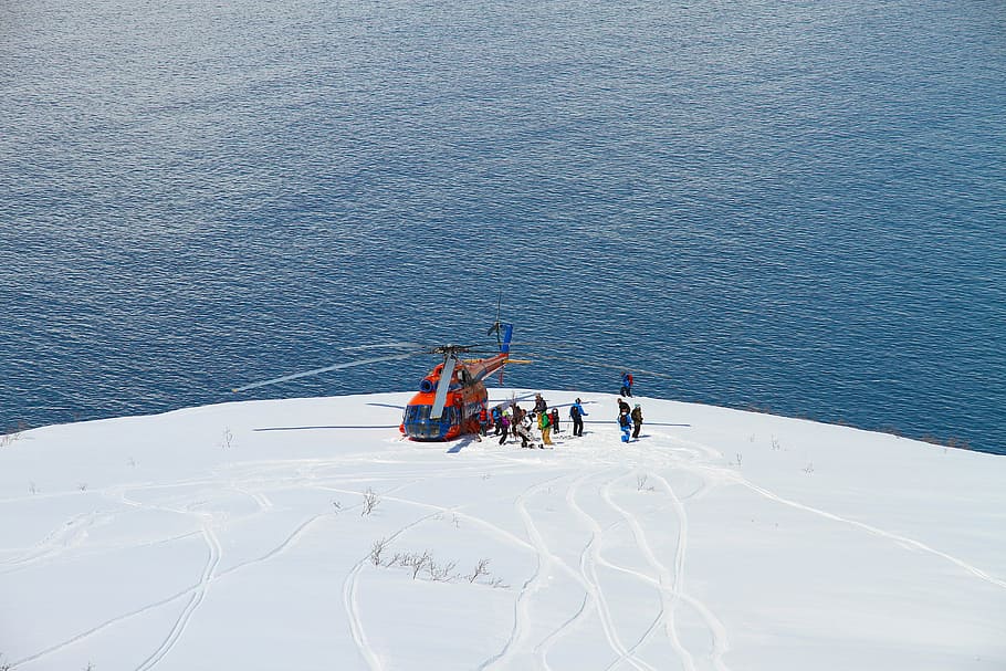 Waiting part II, helicopter landed on snow covered mountain near body of water HD wallpaper