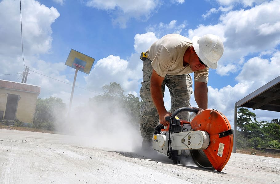 person holding red and gray concrete saw, construction, worker HD wallpaper