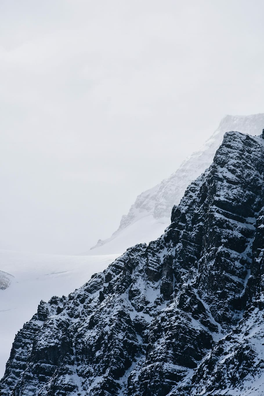 snow covered mountain, black mountains covered with snow during daytime HD wallpaper