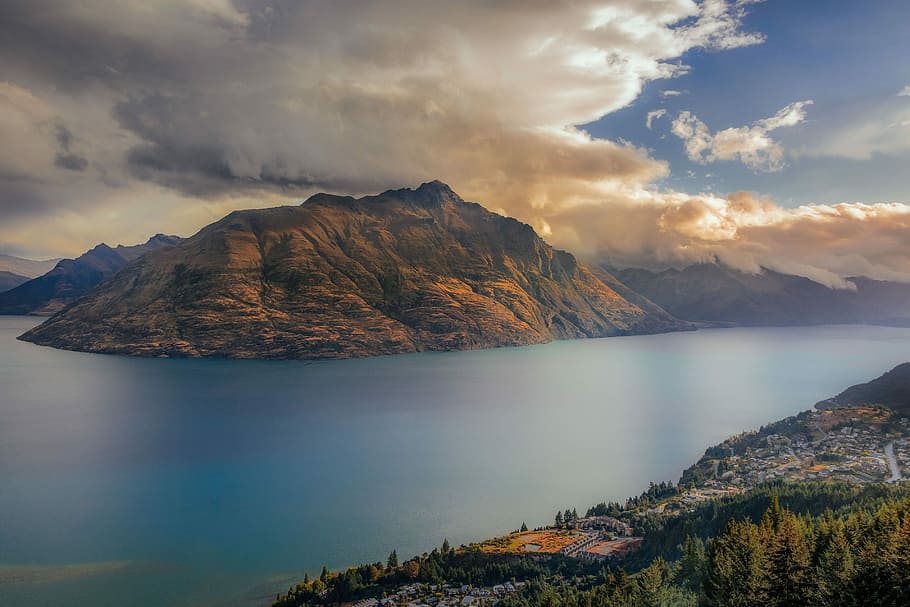 landscape photography of mountain, body of water near mountain under white clouds HD wallpaper