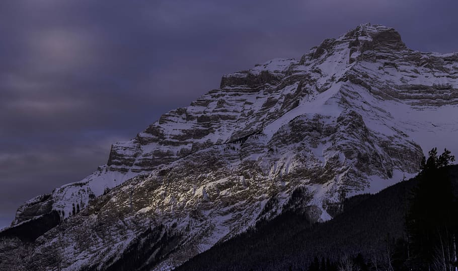 rock mountain covered with snow at daytime, snow covered mountain during nighttime HD wallpaper