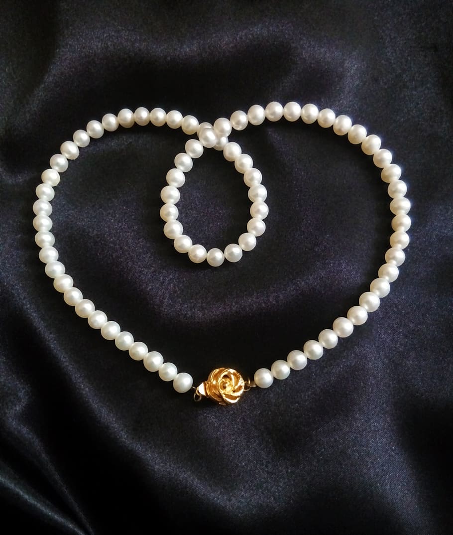 white pearl necklace on black textile, jewelry, pearl strand