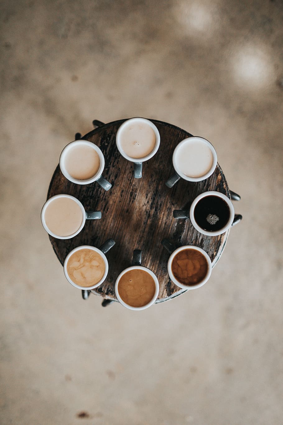 flat lay photography of eight coffee latte in mugs on round table, eight cups with coffee on brown wooden table, HD wallpaper