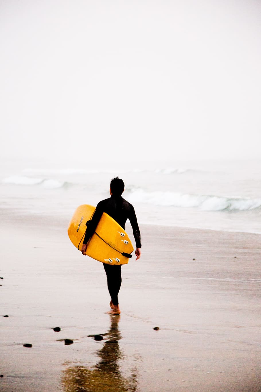 man holding yellow surfboard while walking on seashore during daytime, person holding yellow surfboard HD wallpaper