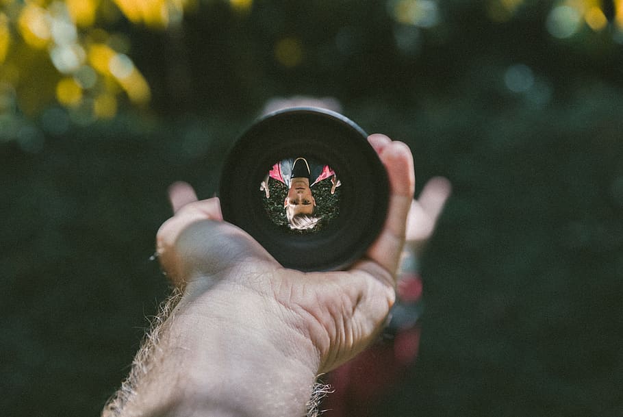person holding camera lens, New Perspective, hand, reflection HD wallpaper