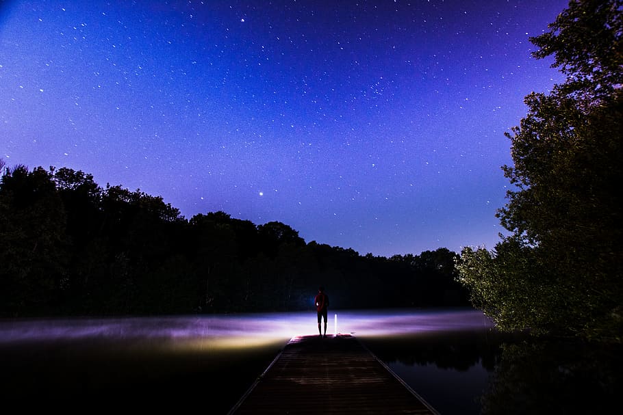 silhouette of person facing purple body of water, person under blue sky HD wallpaper
