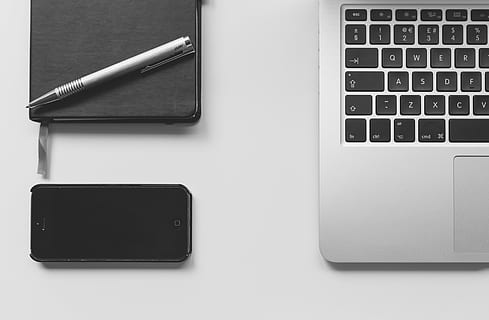 black iPhone 5 beside MacBook, silver, slate, white, surface HD wallpaper