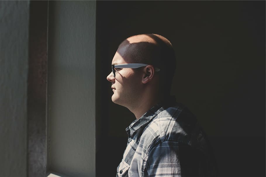 man standing facing window while wearing white temple eyeglasses HD wallpaper