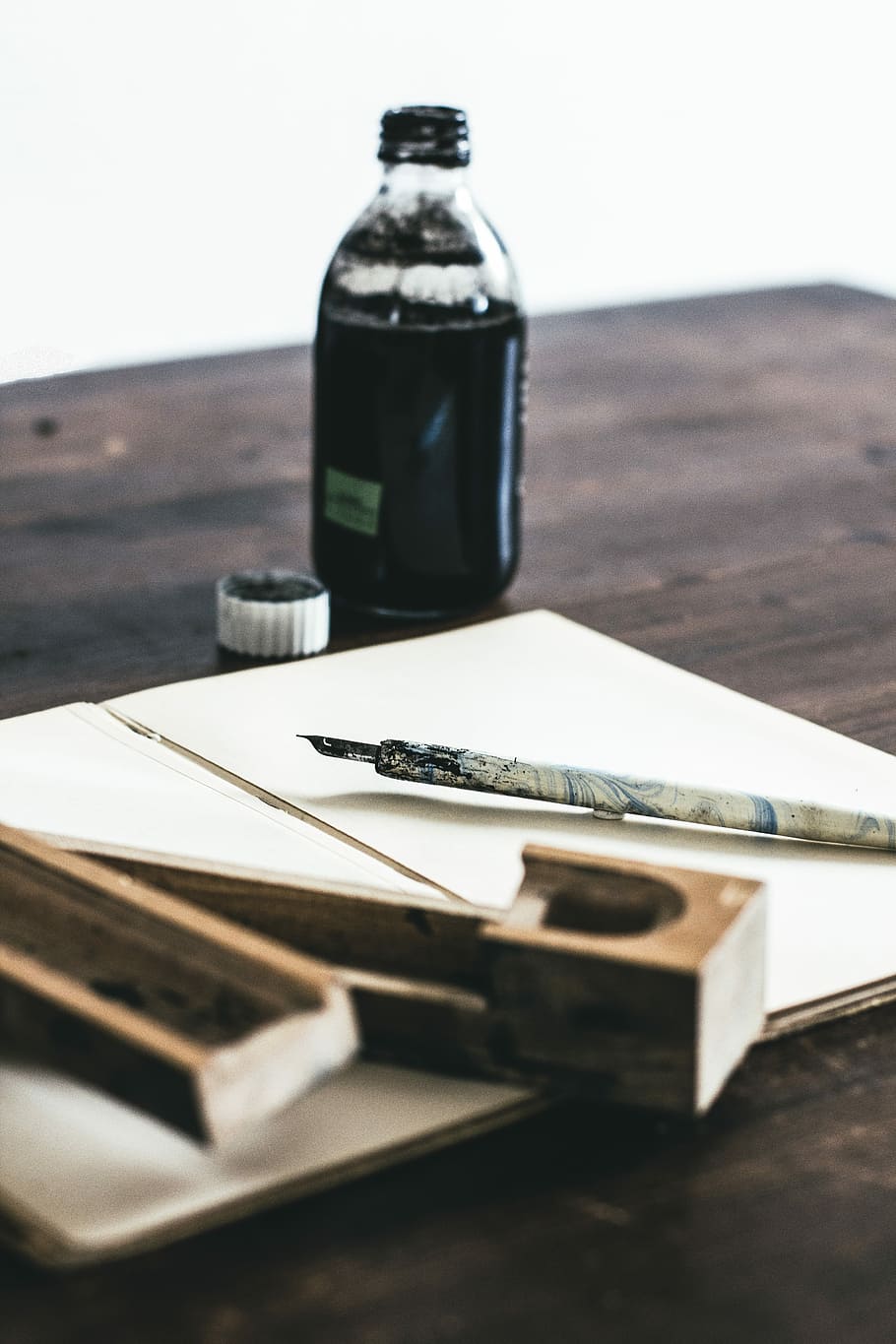 white quill pen near ink bottle, bottle filled with ink on table HD wallpaper
