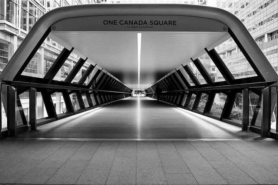 gray scale photo of One Canada Square pathway, grayscale photo of One Canada Square bridge