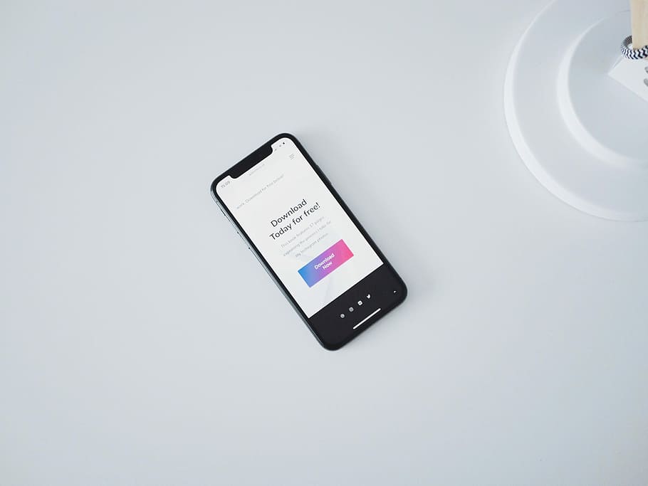 turned on iPhone X on white surface, turned on space gray iPhone X HD wallpaper