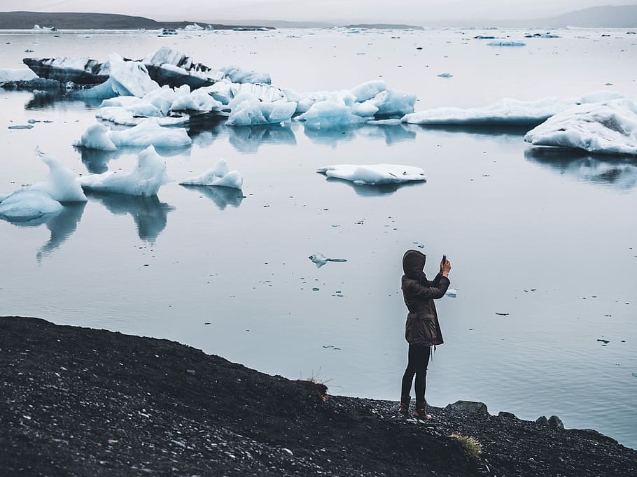 woman taking photo standing near body of water, person standing beside body of water HD wallpaper