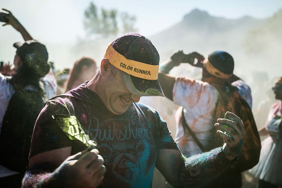 man standing near people taking pictures, man in cap covered of paint during daytime HD wallpaper