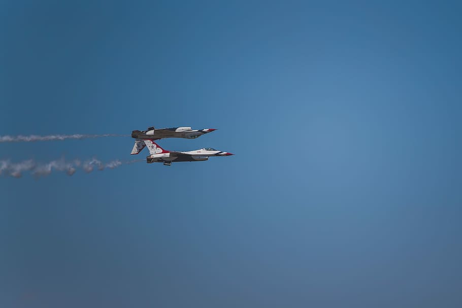 low-angle photography of two white-and-blue aircraft, two jet plane on blue skies HD wallpaper