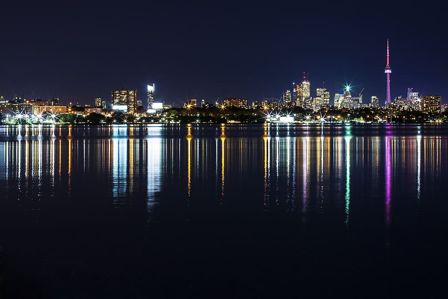 far view of city buildings during daytime, reflecting photography of cityscape HD wallpaper