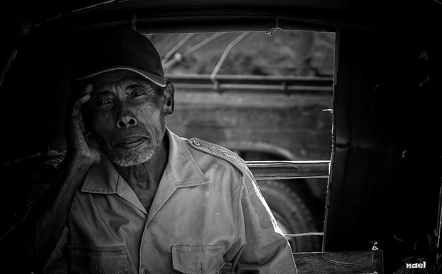 grayscale photo of man, grayscale photo of man holding his head near window HD wallpaper