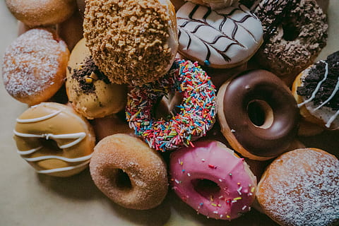 assorted flavor donuts, assorted-flavored donuts on brown surface HD wallpaper
