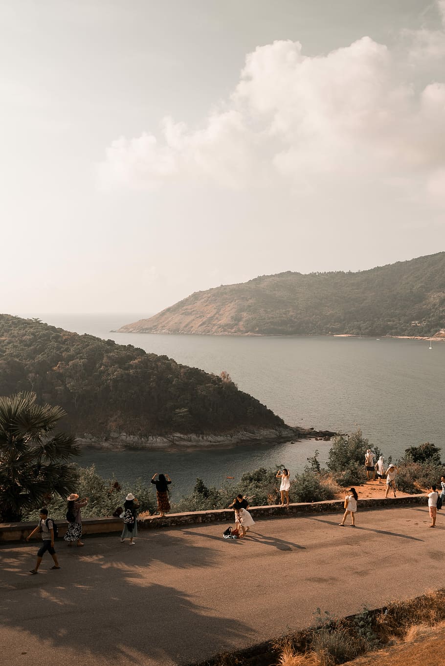 people on concrete road near body of water, people walking on road beside body of water HD wallpaper